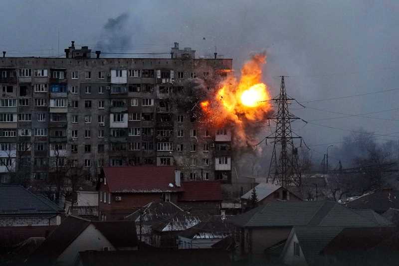 An apartment building explodes after a Russian army tank fires in Mariupol, Ukraine, Friday, March 11, 2022. (AP Photo/Evgeniy Maloletka)